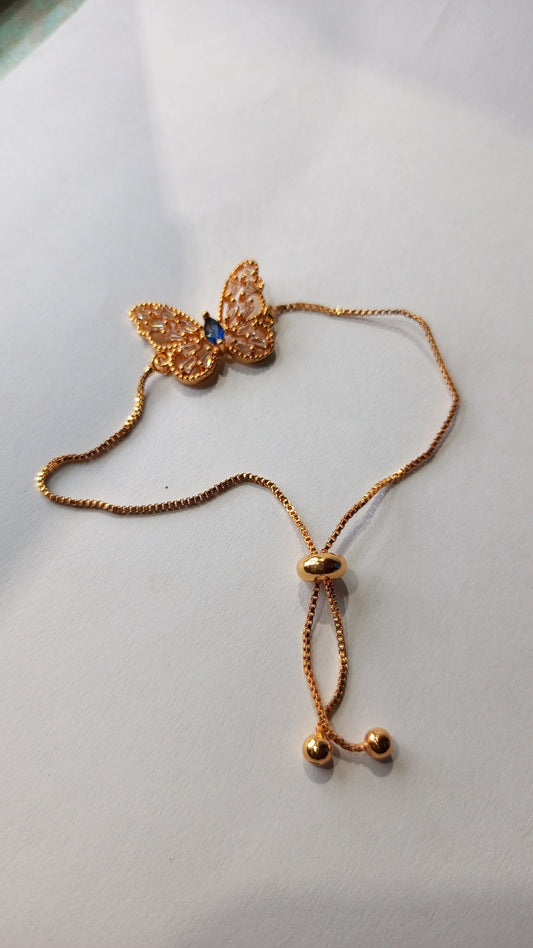 Elegant Butterfly Charm Bracelet – Gold with Blue Gem Accent